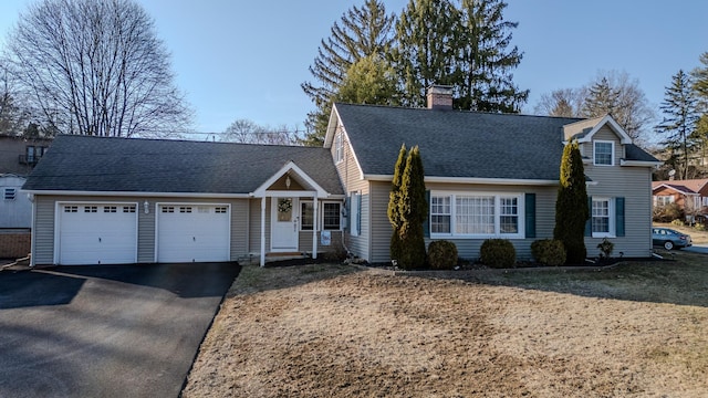 cape cod-style house with aphalt driveway, a garage, roof with shingles, and a chimney