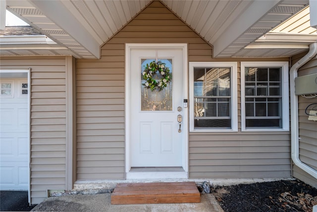 entrance to property featuring an attached garage