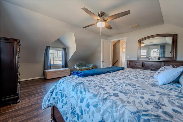 bedroom featuring a ceiling fan, dark wood-style floors, baseboards, visible vents, and lofted ceiling