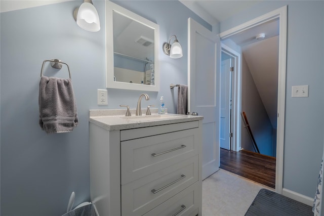 full bath featuring vanity, baseboards, and visible vents