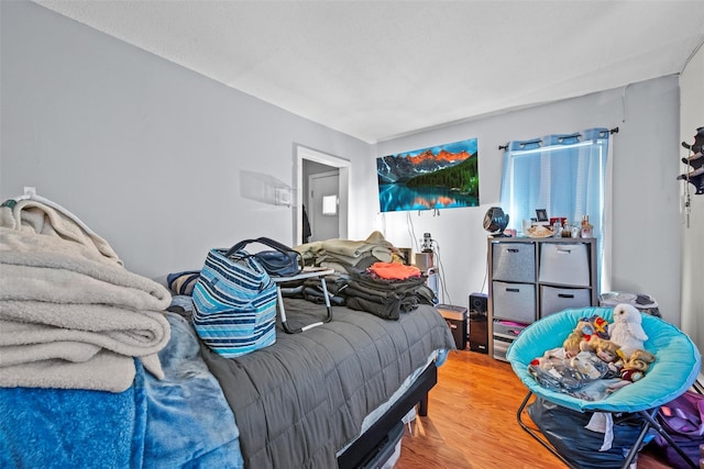 bedroom featuring wood finished floors