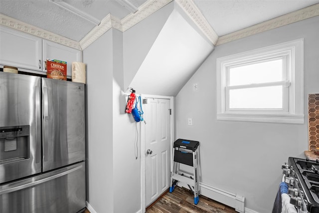 kitchen with vaulted ceiling, wood finished floors, baseboards, and stainless steel appliances