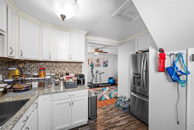 kitchen featuring tasteful backsplash, dark wood-style floors, stainless steel refrigerator with ice dispenser, and white cabinetry