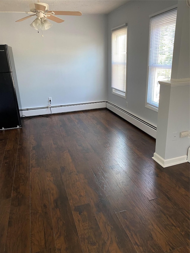 unfurnished room with hardwood / wood-style flooring, a ceiling fan, baseboards, and a textured ceiling