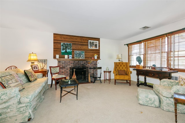 living area featuring visible vents, a fireplace, and carpet