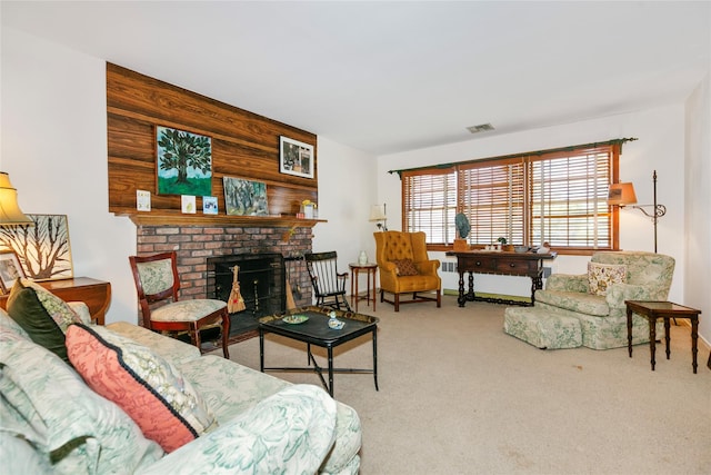 carpeted living area with visible vents, wood walls, and a fireplace