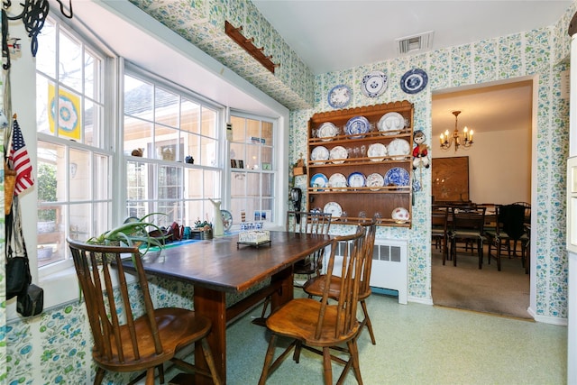 dining space with visible vents, wallpapered walls, baseboards, radiator heating unit, and an inviting chandelier