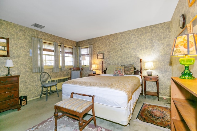 carpeted bedroom featuring visible vents, wallpapered walls, and baseboards