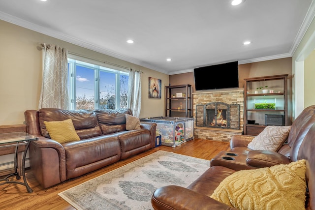 living area with wood finished floors, a fireplace, and ornamental molding