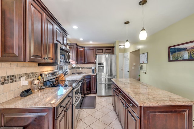 kitchen featuring backsplash, a center island, light tile patterned floors, stainless steel appliances, and a sink