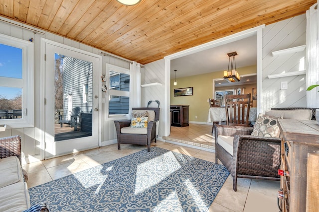 tiled living area featuring wooden ceiling, baseboards, and a chandelier