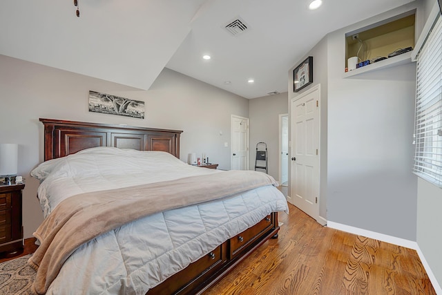 bedroom featuring recessed lighting, wood finished floors, visible vents, and baseboards