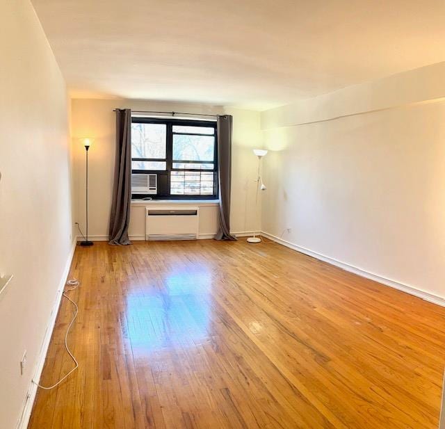 empty room with baseboards and light wood finished floors