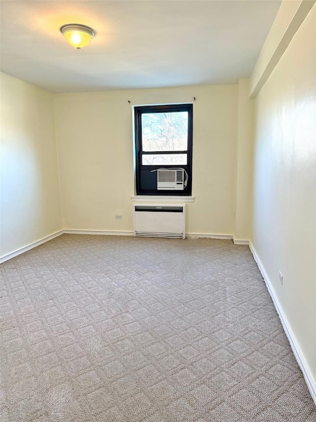 unfurnished room featuring cooling unit, carpet, and baseboards