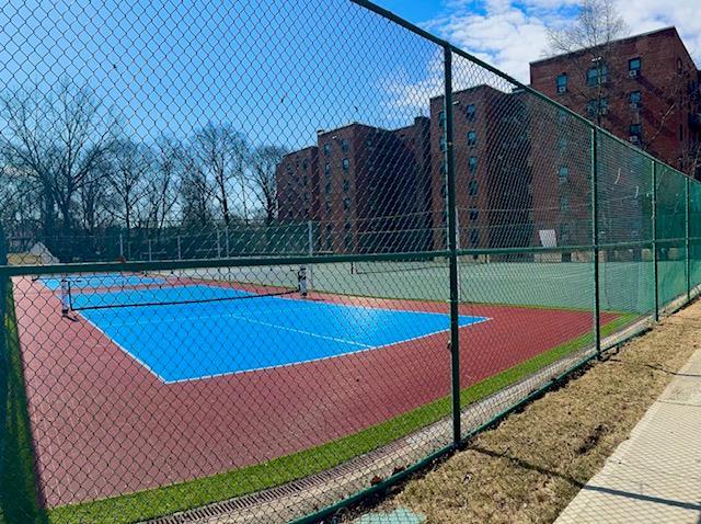 view of tennis court featuring fence