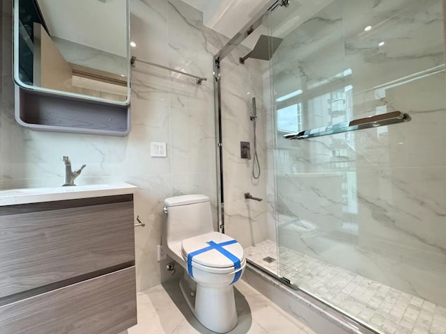 full bathroom featuring a marble finish shower, toilet, and vanity