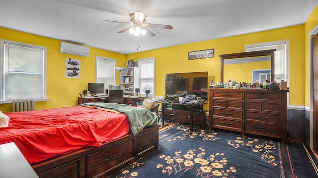 bedroom featuring ceiling fan, radiator heating unit, dark carpet, and a wall mounted AC