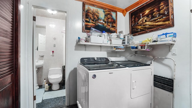 washroom featuring washing machine and clothes dryer and laundry area