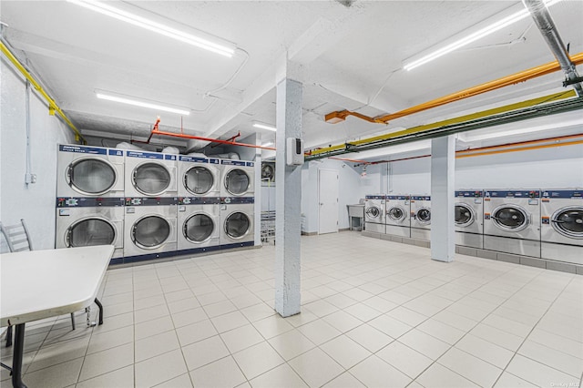 community laundry room featuring washing machine and dryer and stacked washing maching and dryer