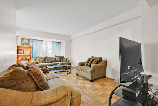 living area featuring baseboards