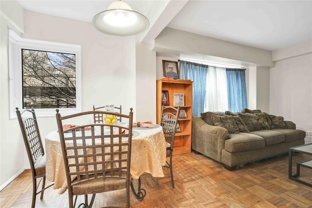 dining room featuring a healthy amount of sunlight and baseboards