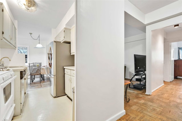 corridor with baseboards and a sink