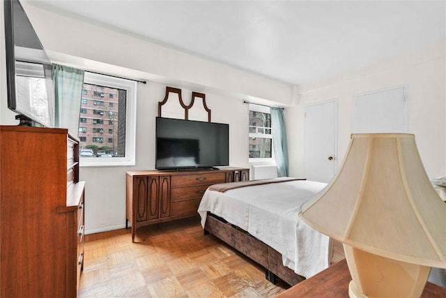 bedroom featuring multiple windows and baseboards