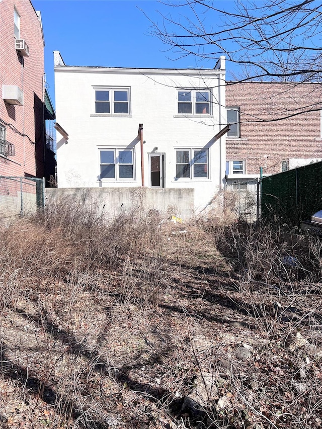 rear view of property with fence