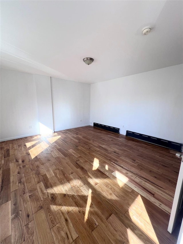 spare room featuring wood finished floors