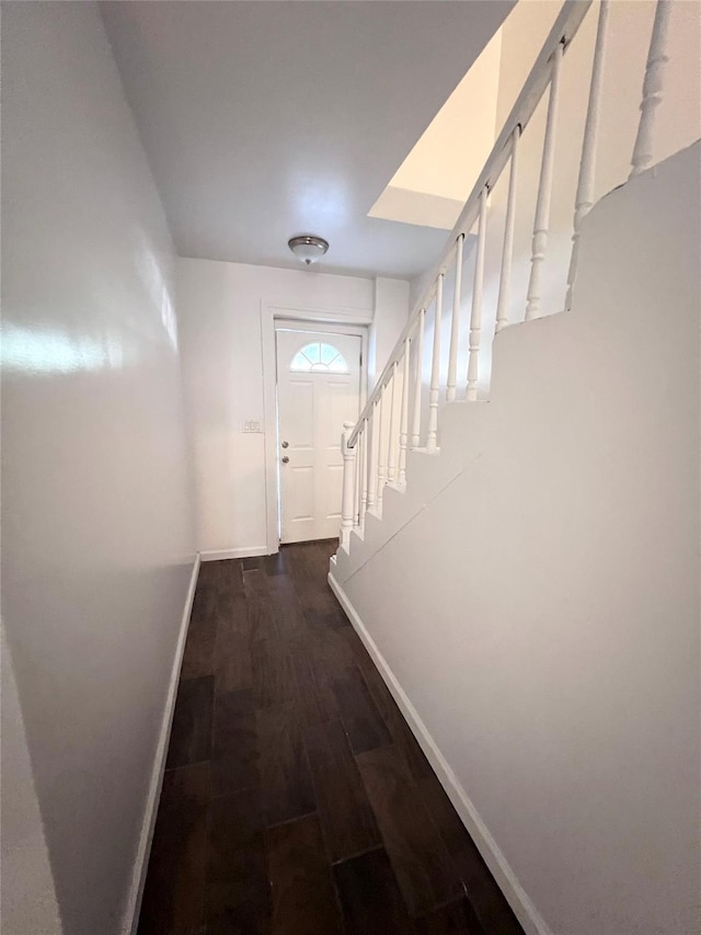 doorway to outside with stairway, dark wood-style floors, and baseboards