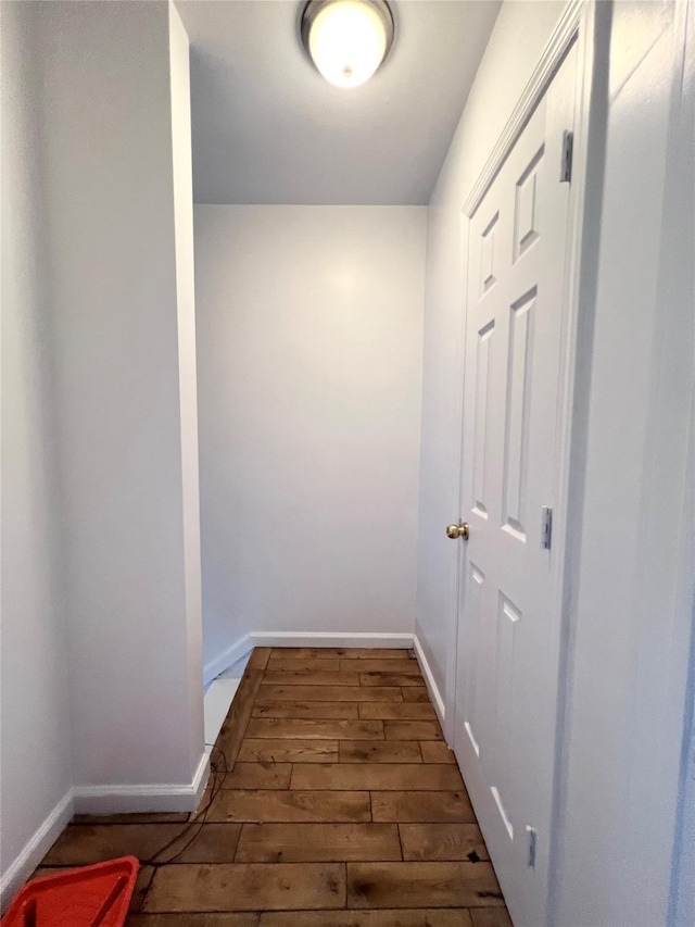 hall featuring wood finished floors and baseboards