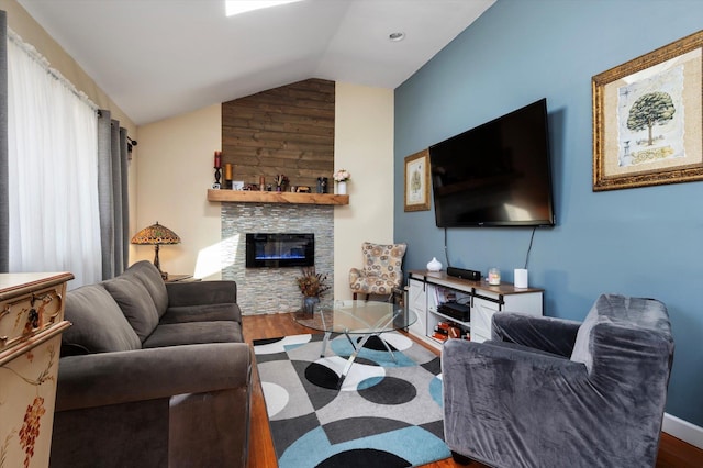 living room featuring a fireplace, vaulted ceiling, wood finished floors, and baseboards