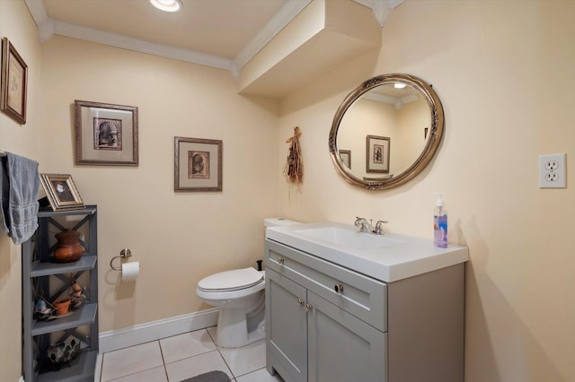 bathroom featuring tile patterned flooring, baseboards, toilet, ornamental molding, and vanity