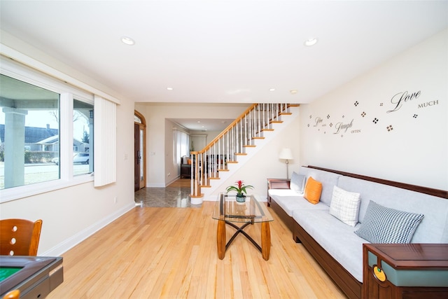 living room featuring stairway, recessed lighting, baseboards, and wood finished floors