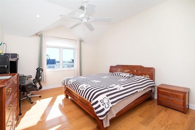 bedroom featuring visible vents, a ceiling fan, light wood-style floors, baseboards, and vaulted ceiling