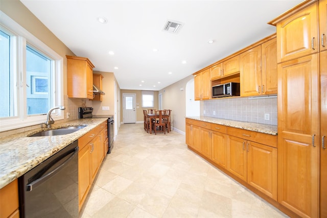 kitchen with visible vents, light stone countertops, electric range oven, dishwashing machine, and a sink