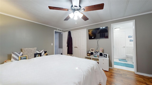 bedroom featuring light wood-type flooring, visible vents, ornamental molding, a ceiling fan, and ensuite bath