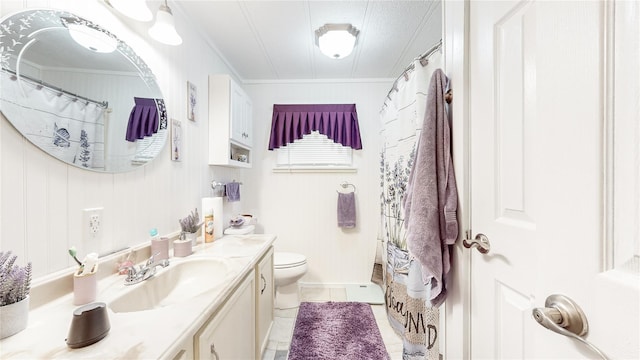 bathroom featuring tile patterned flooring, toilet, vanity, and ornamental molding