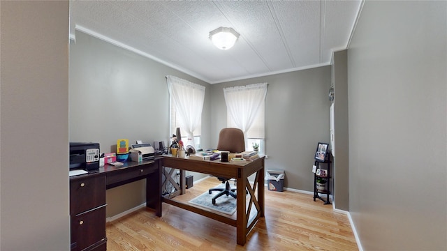 office area with crown molding, baseboards, light wood finished floors, and a textured ceiling