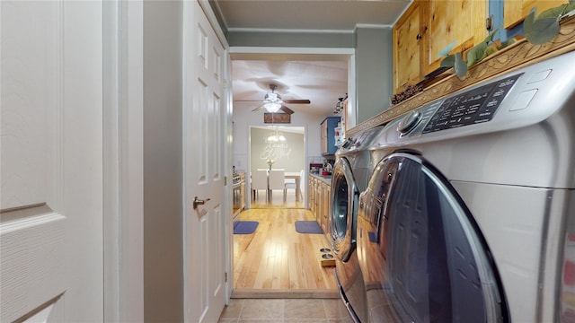 mudroom featuring independent washer and dryer and ceiling fan with notable chandelier