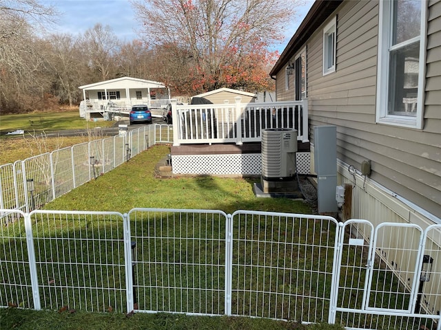 view of yard with a gate, cooling unit, an outdoor structure, a deck, and fence private yard