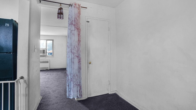 hallway featuring carpet flooring, radiator heating unit, and cooling unit