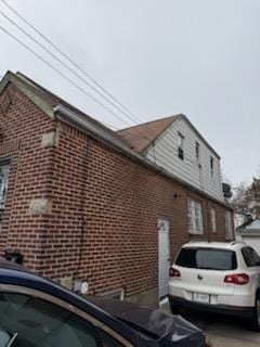 view of side of property featuring brick siding