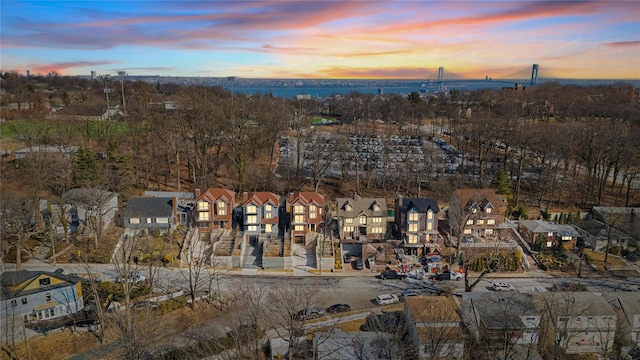 aerial view at dusk featuring a residential view