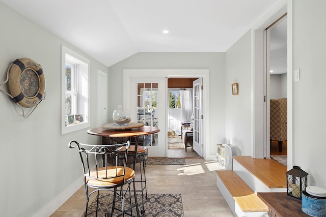 dining space featuring vaulted ceiling