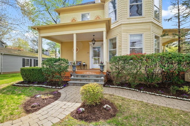 view of exterior entry featuring a porch