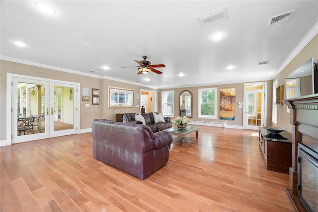 living area featuring french doors, baseboards, a baseboard heating unit, and visible vents