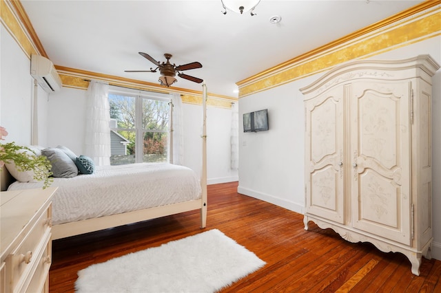 bedroom featuring crown molding, baseboards, a wall unit AC, and hardwood / wood-style floors