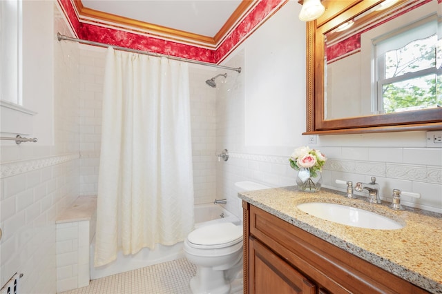bathroom with shower / bath combination with curtain, tile walls, tile patterned floors, vanity, and toilet