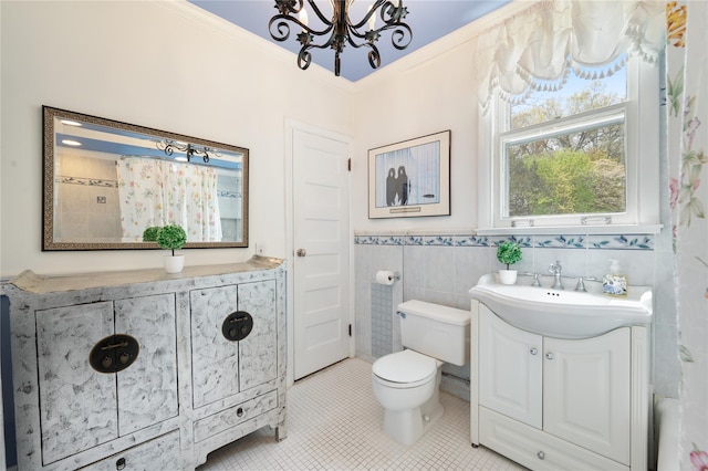66 Drake Rd, Scarsdale, NY 10583 - bathroom featuring a chandelier, vanity, toilet, tile patterned flooring, and tile walls